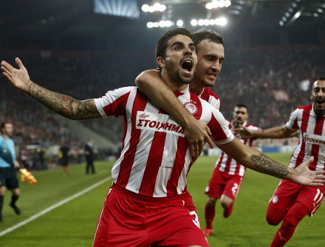 Paulo Machado celebrates his goal on the 4th minute and captain Vassilis Torossidis congratulates him.