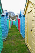 Beach huts, ready for the summer, sitting in the car park. (llanbedrog beach huts)