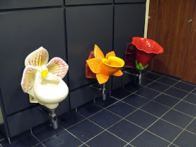 three psychedelic flower toilets