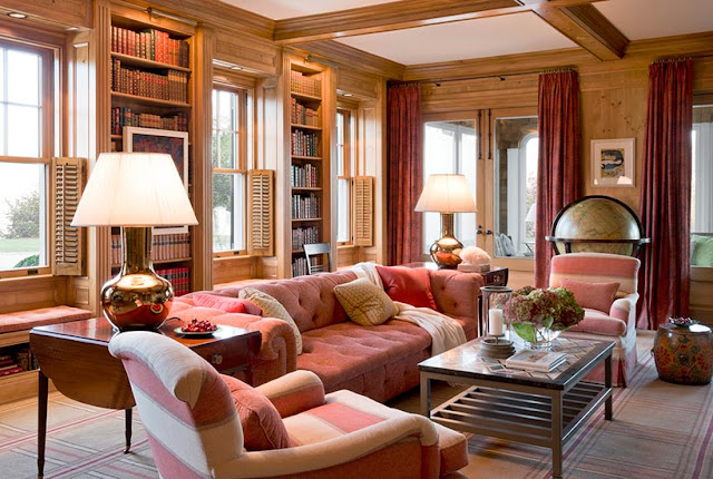 Rose tufted sofas in panelled library den in Meadowmere Southampton home by Carrier and Company