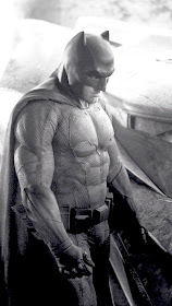  Director Zack Snyder revealed the black-and-white photo Tuesday on Twitter.         @ZackSnyder/Twitter     The first image of Ben Affleck as Batman in the upcoming Superman-Batman film has hit the web.  * This image has been altered to allow better exposure of the rest of the suit. Looks prety cool.   -GeekSummit  Director Zack Snyder unveiled the photo via Twitter on Tuesday, after teasing the day before that a Batman reveal of some sort was coming.  The monochromatic image features Affleck in the Batsuit with the new Batmobile at his side, as smoke looms in the background.     Affleck was cast in the role last August and the announcement was met with mixed reaction. (Snyder said at the time that Affleck's Batman would be "older and wiser.") In response to Internet backlash, Affleck appeared on Late Night in September to address worries. "They said just don't use the Internet for a couple of days," Affleck said at the time. "I handle shit. I'm very tough. I saw the announcement, I look down on the first comment … the first one just goes, 'Nooooooooo!' "  Snyder's Superman-Batman follow-up will return Henry Cavill, who starred in Man of Steel, as Superman. Gal Gadot will play Wonder Woman, Jesse Eisenberg has been cast as Lex Luthor, Jeremy Irons is set as Alfred and Ray Fisher will portray Victor Stone/Cyborg. Holly Hunter, Callan Mulvey and Tao Okamoto are also in the cast and will play newly created characters.  Affleck, Cavill and Gadot are expected to reprise their roles for the Justice League movie, which will also be directed by Snyder and have a 2017 release.  Warner Bros. has slated the Batman-Superman tentpole for May 6, 2016     Source: Hollywood Reporter 