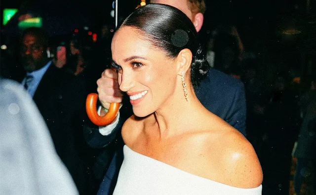 Meghan Markle, Duchess of Sussex wore a Theo black-and-white striped tube dress by Posse. Cult Gaia Nia clutch