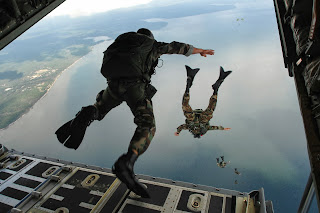U.S. Air Force Airmen from the 720th Special Tactics Group jump out of a C-130J Hercules aircraft during water rescue training above Choctawhatchee Bay, over the Destin coastline in Florida – Senior Airman Julianne Showalter