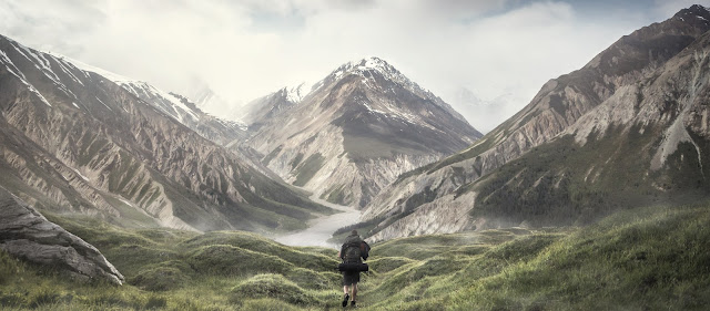 hiker approaching mountain