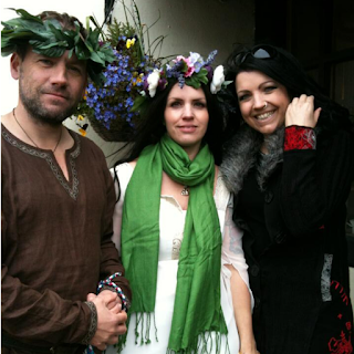 Handfasted couple wearing flowers crowns standing with a female friend