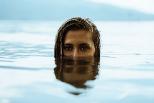 A woman is practicing her self awareness during her diving session