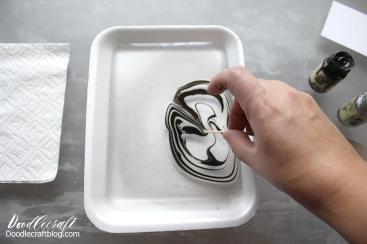 Supplies needed for Easy Marble marbling.  Styrofoam shallow dish with 1/4 inch of water.  Easy Marble in black and white.  White card stationery.  Toothpick, gloves, paper towels, acetone.