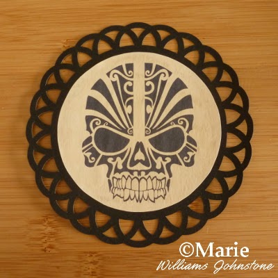 Black circle skull motif on a scallop edge black card frame