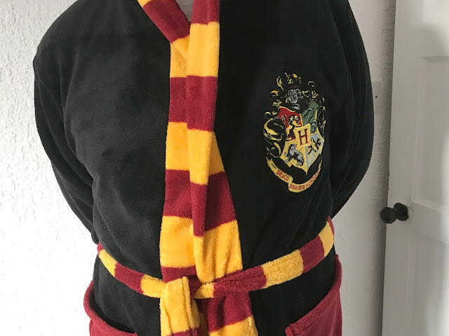 black dressing gown with Harry Potter crest logo on 