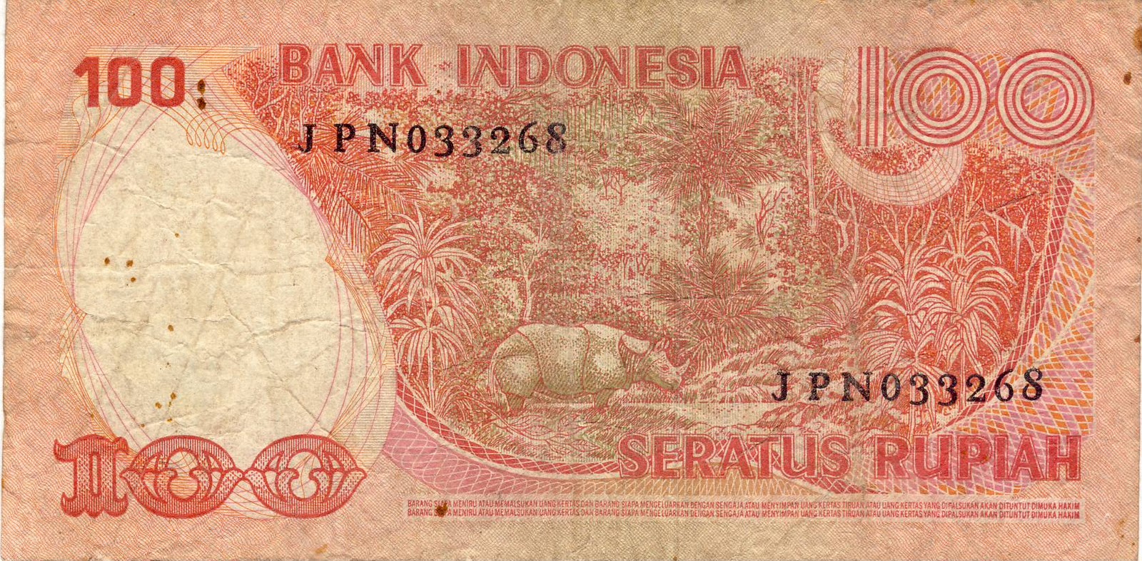 Uang kertas Rp. 100 (seratus) Rupiah Indonesia bergambar Badak Jawa