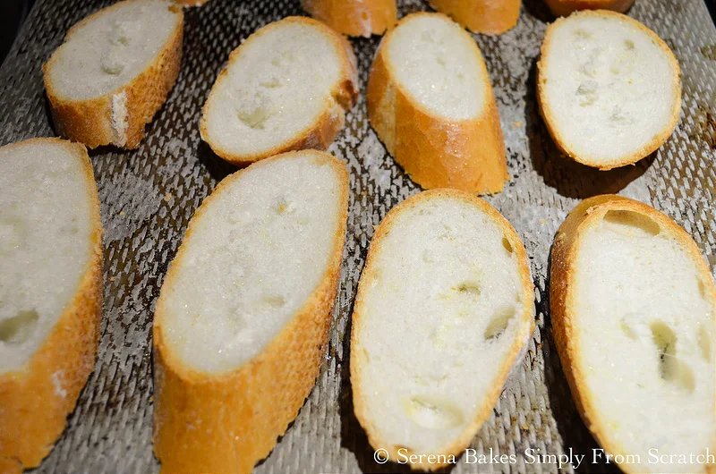 Sliced baguette on a baking sheet.