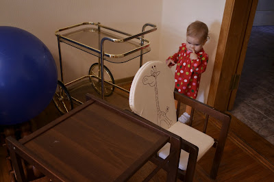 a small girl is standing and thinking in the living-room