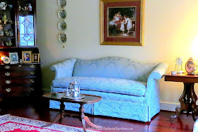 Damask sofa and antiques in the living room.