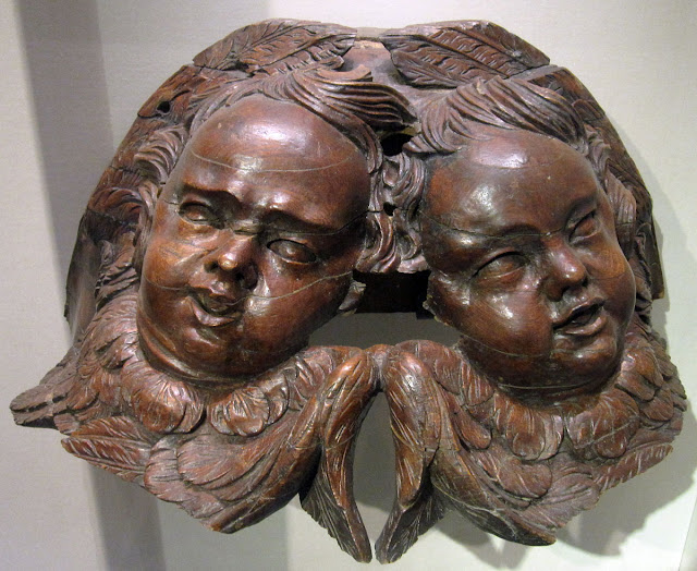 Cherub heads from the 1705 Smith organ case in St. David's Cathedral, Eglwys Gadeiriol Tyddewi; St. David's (Tyddewi), Pembrokeshire.  8 July 2011.