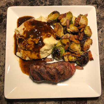 Rare grilled bison New York strip, mashed potatoes and bacon roasted Brussels sprouts