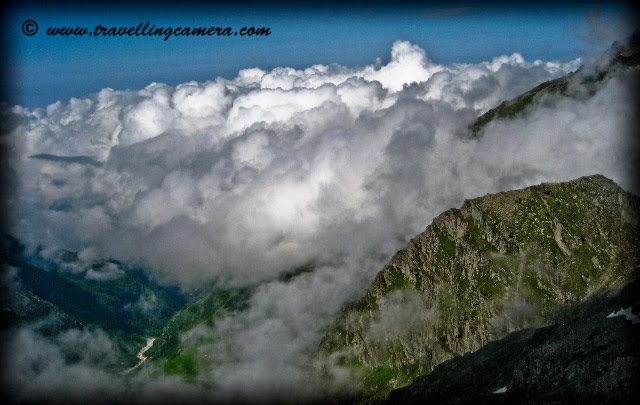 What all we see after reaching Shrikhand Mhadev @ 19000 feets: Posted by VJ @ Travellingcamera.com Its been two years when I have experienced all these things and  still I remember  most of the things very clearly. It was really an amazing experience for me and probably the best ...Here are few more photographs of Shrikhand Mahadev...Last day trek gives extremely different experince on snow covered hills with low oxygen level... I was not able to enjoy this beauty while crossing this area... Sometimes low oxygen makes you unconscious..After reaching near Shivlingam, there is only snow and huge rocks around the place. Hard to find out grass, flowers, plants on these hills...There is heavy cloud movement  around these hills and sometimes  we  had to slow down our movement because of visibility issues...Beautiful view of mountains and clouds on trek to Shrikhand MahadevClouds, and sunlight over a mountain on trek to Shrikhand MahadevI say it Cloud Store @ Shrikhand Mahadev :)I say it Cloud Store @ Shrikhand Mahadev :) It was a huge area between hundreds of mountains and we found it completely filled with these clouds in early morning... When we came back, there was no differences and we started guessing about the area below these clouds...Shrikhand Mahadev is one of the adobes of Lord Shiva. People worship the natural, rock-made shiva-lingam which is approx 72 feet high. The view is breathtaking form the top. There are 2 ways to reach to the top, one is from Neermand and another from Arsu side: and we took first one. The trek from jaon Village takes approximately 38 kms one side to reach Shrikhand Peak.Srikhand Mahadev peak, located at an altitude of 5200 meters resembles the Shivling. It is said that Lord Shiva meditated here and the Pandavas used to visit this peak. Devotees of Lord Shiva visit at the top of the mountain where there is a small shrine of Lord Shiva. Devotees trek to the peak during the main pilgrimage season of July and August.I recommend you to carry plenty of water, energy bars, Glucose, walking stick and torch with you. These things make your trek quite comfortable... Don't forget some basic medicines by consulting your doctor by describing about this trek :) I found ist most difficult to climb huge rocks in our final strech to Shrikhand Mahadev...It is believed there are total seven Kailash mountains. The well known Mansarovar Kailash in Tibet, Adi Kailash in Pithoragarh district of Uttrakhand, Amarnath Kailash in J&K, Kinner Kailash in Kinnaur district of Himachal Pradesh, Mani Mahesh Kailash in Chamba District of Himachal Pradesh,Sri Khand Kailash in Shimla district of Himachal Pradesh. Seventh one is believed to be Boorha Kailash and is yet to be located. A Lovely flower on the way to Shrikhand Mahadev...