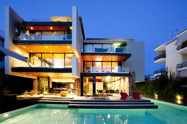 Picture of modern house at sunset as seen from the pool area by the terrace