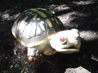 a large, realistically painted turtle sculpture from the nature playscape behind the Dorothy Pecaut Nature Center