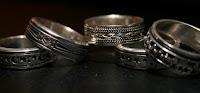 Five silver fidget rings.