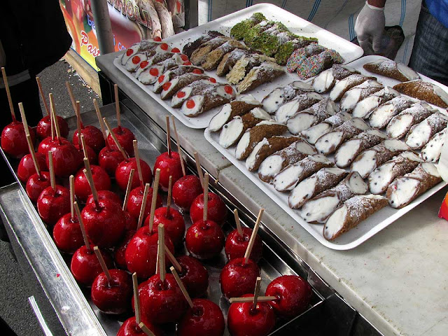 Sicilian cannoli and candy apples, food fair, Livorno