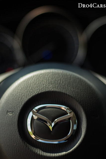 The Mazda logo of the steering wheel of the 2015 Mazda CX-5.