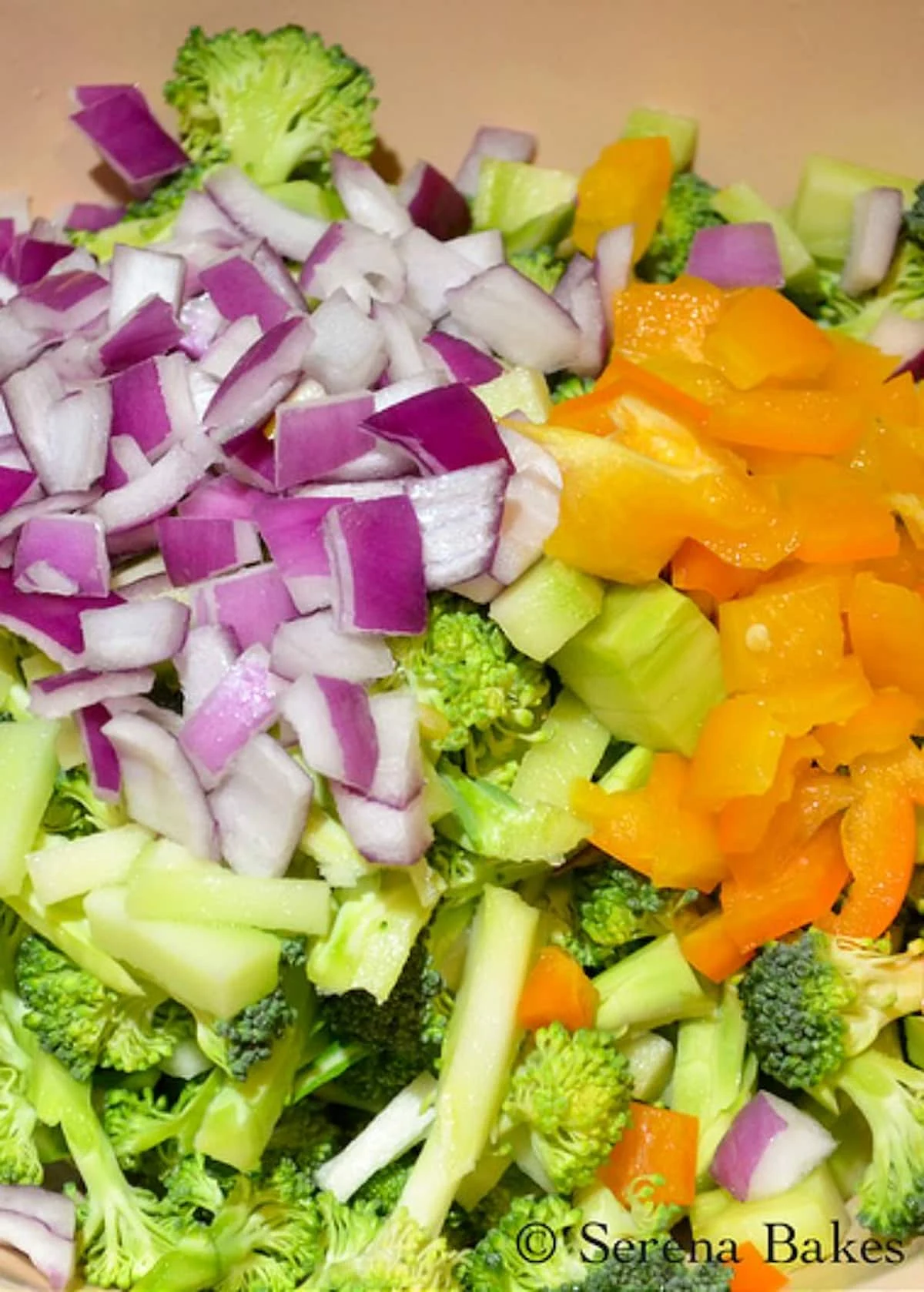 Chopped Broccoli, Red Onion and Diced Bell Pepper in a bowl.