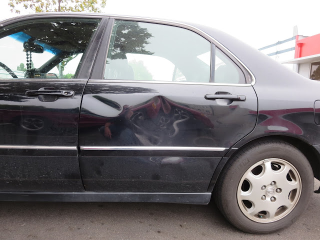 Dented door on Acura RL before repairs at Almost Everything Auto Body