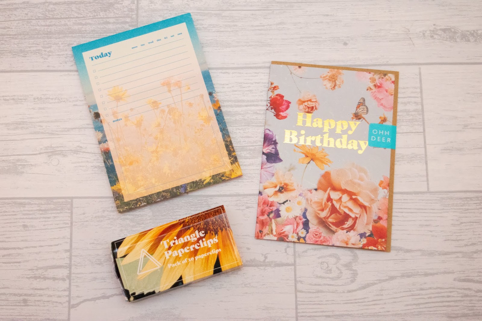 A list pad, box of paperclips and a birthday card