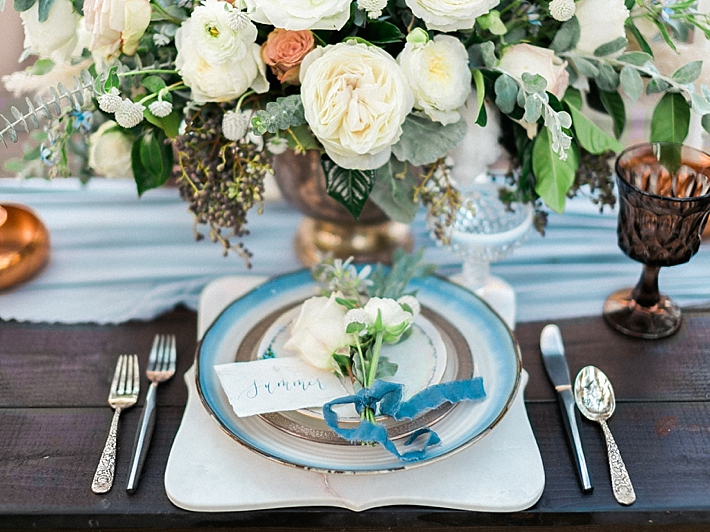 Elegant place settings on top of marble chargers with calligraphy name cards | Photo by Dennis Roy Coronel | See more on thesocalbride.com