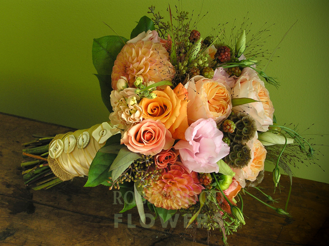 Apricot and salmon colored dahlias with garden roses with a charming vintage