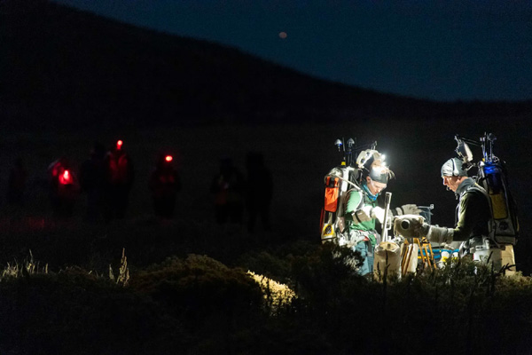 NASA astronauts Zena Cardman and Drew Feustel practice using an early version of the Handheld Universal Lunar Camera during the Joint Extravehicular Activity and Human Surface Mobility Test Team Field Test #3 in Arizona.