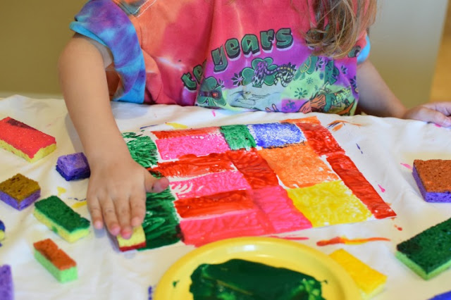 Fit-It-Together Sponge Painting. Great process art activity to explore square and rectangle shapes! Preschoolers, kindergartners, and elementary kids will work on spatial skills while making beautiful art!