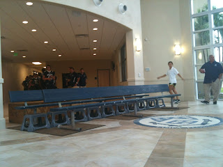 In the entrance of the Straz Family Field House, the benches have been laid out and the seal is down in front.