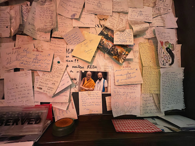 the walls of The Pudding Shop are covered in photographs, notes, and postcards from travelers