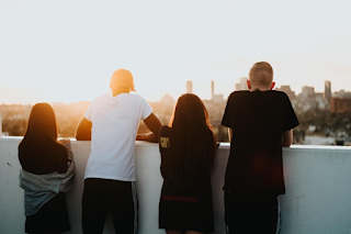 View from behind four people looking at city