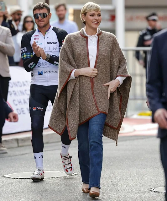 Princess Charlene wore a Sydney leather trim cashmere knit poncho by Loro Piana. COCC 10th annual St Tropez to Monaco Charity bike ride