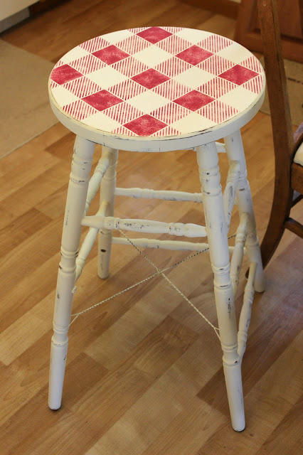 Photo of an old stool upcycled with chalk paint and an Old Sign Stencils buffalo check stencil.