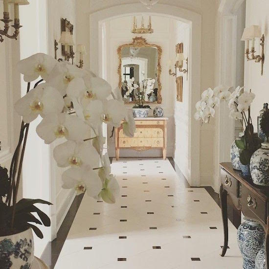 Gorgeous Paris inspired black and white hallway with marble stone floor and orchids by Enchanted Home