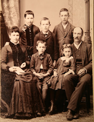 Early 20th studio photo of family arranged.