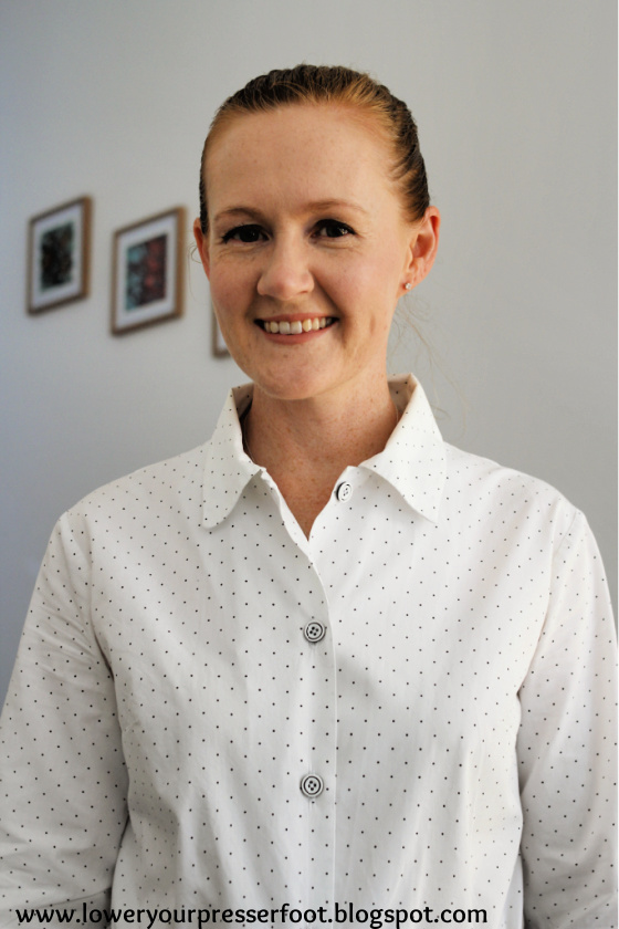 a lady wearing a white and black polka dot shirt