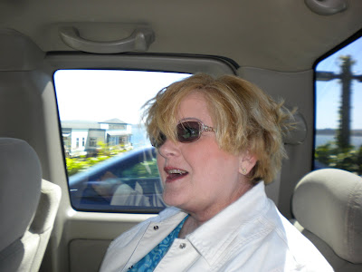 Gram, back in the car, hair blown all to pieces