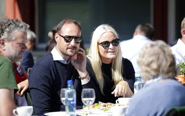 Crown Princess Mette-Marit wore a navy blue cashmere sweater. Fjallraven black and beige trekking trousers