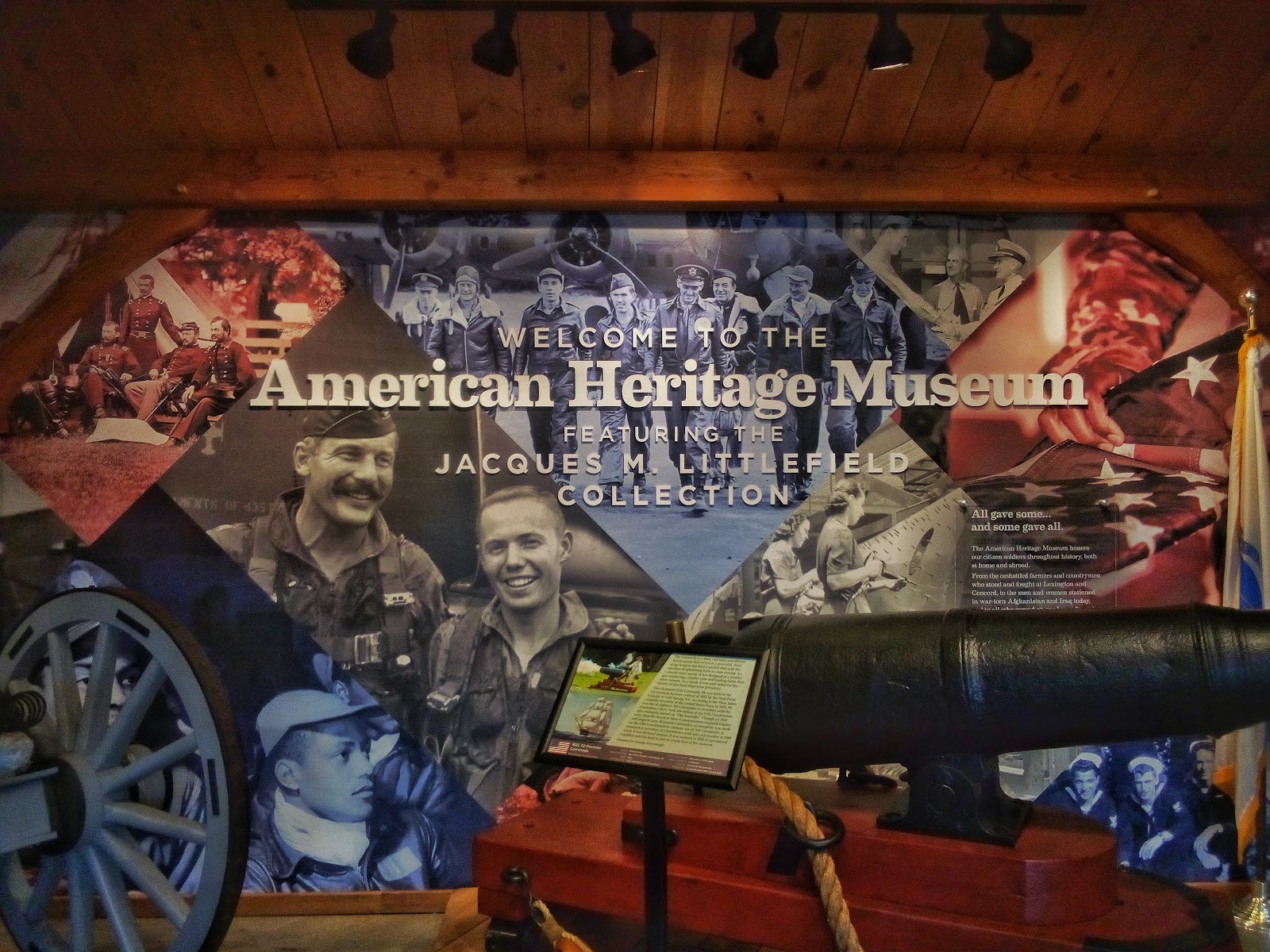 Sign for American Heritage Museum; a colorful collage of soldiers from 20th century wars