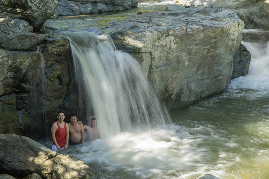 At the water curtain of Tukuran Falls