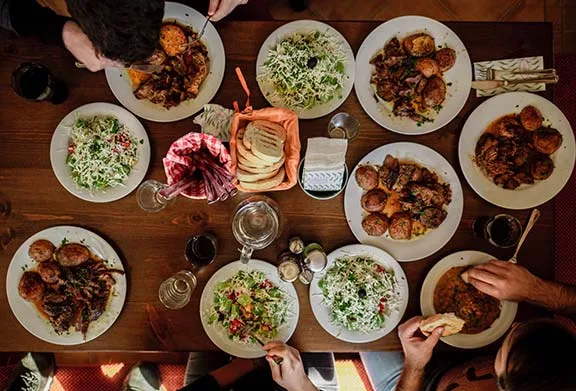 People around a table with food