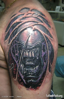 alien creature tattoo on the shoulder