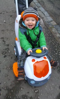 toddler in push along car