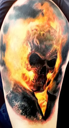 Horror skull with fire tattoo on leg 