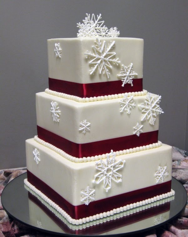 This wedding cake is decorated with sugar snow flakes and beautiful red 