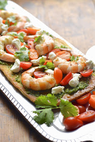 Bake pre-made pizza dough to make the perfect flatbread with grilled shrimp, cilantro pesto and goat cheese.